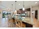 Spacious kitchen with granite countertops, stainless steel appliances, and an island at 31 Tee View Pl, Rotonda West, FL 33947