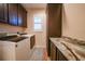 Laundry room with washer, dryer, and granite countertop at 31 Tee View Pl, Rotonda West, FL 33947