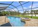Enclosed pool and spa with lake view; paver deck at 31 Tee View Pl, Rotonda West, FL 33947