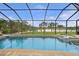 Inviting screened pool and spa overlooking a tranquil lake at 31 Tee View Pl, Rotonda West, FL 33947