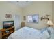 Cozy guest bedroom with a double bed, TV, and built-in closet at 3300 Loveland Blvd # 3103, Punta Gorda, FL 33980