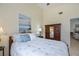 Bedroom with full bed, armoire and ocean art at 3300 Loveland Blvd # 3103, Punta Gorda, FL 33980