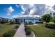 Community clubhouse with landscaping and a walkway at 3300 Loveland Blvd # 3103, Punta Gorda, FL 33980