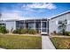 Front view of the house showcasing the landscaping and walkway at 3300 Loveland Blvd # 3103, Punta Gorda, FL 33980