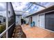 Screened patio with seating area and surrounding greenery at 3300 Loveland Blvd # 3103, Punta Gorda, FL 33980