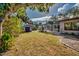 Backyard with shed, screened-in pool, and landscaping at 3404 Depew Ave, Port Charlotte, FL 33952