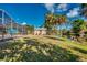 Backyard with a screened-in pool, shed, and waterfront access at 3404 Depew Ave, Port Charlotte, FL 33952
