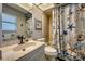 Bathroom featuring a shower, vanity sink, and beach-themed decor at 3404 Depew Ave, Port Charlotte, FL 33952