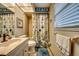 Clean and bright bathroom with beach-themed shower curtain and vanity at 3404 Depew Ave, Port Charlotte, FL 33952