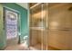 Bathroom featuring a walk-in shower, a single vanity, and a stained-glass accented door at 3404 Depew Ave, Port Charlotte, FL 33952