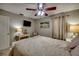 Cozy bedroom with beach-themed decor, ceiling fan, and ample natural light at 3404 Depew Ave, Port Charlotte, FL 33952
