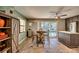 Dining area features table and chairs adjacent to upgraded kitchen and pool view at 3404 Depew Ave, Port Charlotte, FL 33952