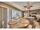 Dining area with pool view, modern kitchen, and ceiling fan at 3404 Depew Ave, Port Charlotte, FL 33952