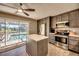 Remodeled kitchen boasts stainless steel appliances, white countertops, and pool access at 3404 Depew Ave, Port Charlotte, FL 33952