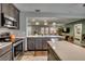 View of the kitchen's sleek countertops, modern appliances, and pass-through opening to the adjacent living space at 3404 Depew Ave, Port Charlotte, FL 33952