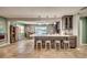 Kitchen island with bar stool seating overlooks open-concept living and dining areas at 3404 Depew Ave, Port Charlotte, FL 33952