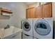 Laundry room featuring a washer, dryer, sink, and cabinetry at 3404 Depew Ave, Port Charlotte, FL 33952
