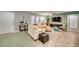 Living room with two sofas, ceiling fan, and large TV at 3404 Depew Ave, Port Charlotte, FL 33952