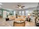 Living area with comfortable seating, natural light, and ceiling fan at 3404 Depew Ave, Port Charlotte, FL 33952