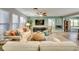 Living room with sofas, ceiling fan, and tile flooring at 3404 Depew Ave, Port Charlotte, FL 33952