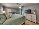 Large Primary bedroom with a king-size bed, a dresser, and stylish decor at 3404 Depew Ave, Port Charlotte, FL 33952