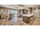 Open kitchen with dining area, pool view, and updated appliances. Island with seating at 3404 Depew Ave, Port Charlotte, FL 33952
