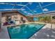 Screened-in pool and patio area with pool toys at 3404 Depew Ave, Port Charlotte, FL 33952