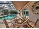 Screened-in pool with a patio table and lush greenery at 3404 Depew Ave, Port Charlotte, FL 33952