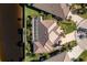 Top down aerial view of home with tile roof, screened lanai, and dock at 3700 Candia Dr, Punta Gorda, FL 33950