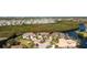 Birds-eye view of home with circular driveway, landscaping, and surrounding properties at 3700 Candia Dr, Punta Gorda, FL 33950