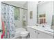 Clean and functional bathroom with shower/tub combo, white cabinets, and tile floors at 3700 Candia Dr, Punta Gorda, FL 33950