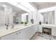 Large bathroom with double sink vanity, mirrors, and white cabinetry at 3700 Candia Dr, Punta Gorda, FL 33950