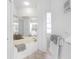 Bright bathroom with a large soaking tub, tile floors, and ample storage space at 3700 Candia Dr, Punta Gorda, FL 33950