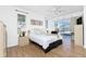 Spacious bedroom with large bed, wood floors, and access to a pool area at 3700 Candia Dr, Punta Gorda, FL 33950