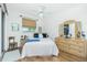 Cozy bedroom with wood-look floors, ceiling fan, and ample natural light at 3700 Candia Dr, Punta Gorda, FL 33950