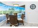 Breakfast area with wicker furniture, pool views, and natural light at 3700 Candia Dr, Punta Gorda, FL 33950