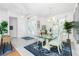 Bright dining room with white tile floor, glass table, and views of the entryway at 3700 Candia Dr, Punta Gorda, FL 33950