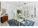 Dining room featuring a glass-top table, decorative rug, and mirrored wall at 3700 Candia Dr, Punta Gorda, FL 33950
