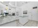 White kitchen with granite countertops, island, and stainless steel appliances at 3700 Candia Dr, Punta Gorda, FL 33950