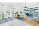 Living and dining area with wood and tile flooring, a ceiling fan, sliding glass door and high ceilings at 3700 Candia Dr, Punta Gorda, FL 33950