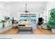 Spacious living room with high ceilings, wood flooring, ceiling fan, and built-in shelving at 3700 Candia Dr, Punta Gorda, FL 33950