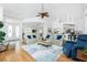 Open concept living area with high ceilings, wood floors, a ceiling fan, and plush furniture at 3700 Candia Dr, Punta Gorda, FL 33950