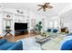 Inviting living area with plush seating, wood floors, and a ceiling fan, centered around a coffee table at 3700 Candia Dr, Punta Gorda, FL 33950