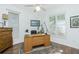 Home office space featuring a wooden desk, chair, and natural light from shuttered windows at 3700 Candia Dr, Punta Gorda, FL 33950