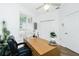 Bright home office with a desk, chair, and large windows with plantation shutters at 3700 Candia Dr, Punta Gorda, FL 33950