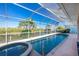 Tranquil pool area enclosed by a screen with views of the canal at 3700 Candia Dr, Punta Gorda, FL 33950