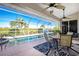 Relaxing outdoor pool area with a screened enclosure, patio furniture, and lush landscaping at 3700 Candia Dr, Punta Gorda, FL 33950