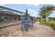 Brick patio with comfortable seating overlooking the pool and lake at 3780 Cobblestone Ln, Punta Gorda, FL 33980