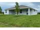 Backyard with a covered patio and green grass at 384 Prineville St, Port Charlotte, FL 33954
