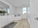 Bright, spacious bathroom with white vanity, soaking tub, glass shower, and tile flooring at 384 Prineville St, Port Charlotte, FL 33954
